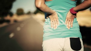 Female-runner-athlete-back-injury-and-pain-585x329
